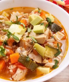 image of white bowl of chicken soup with veggies