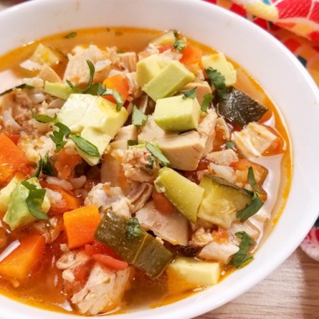 image of white bowl of chicken soup with veggies