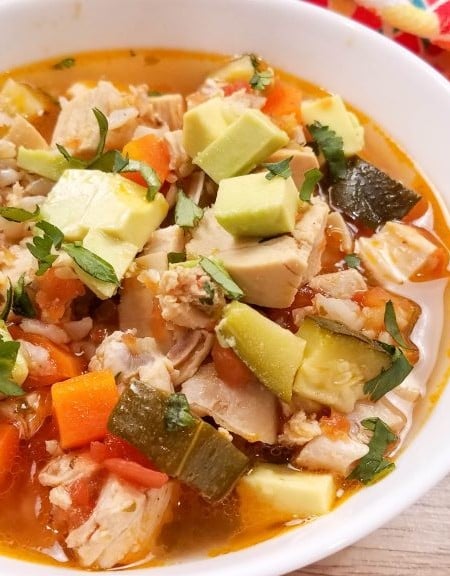 image of white bowl of chicken soup with veggies