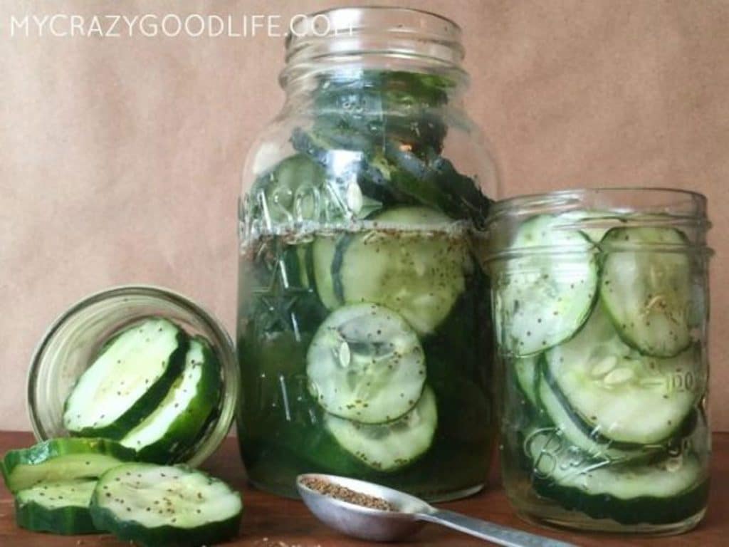 three jars of sweet pickles - one large in the middle and two small