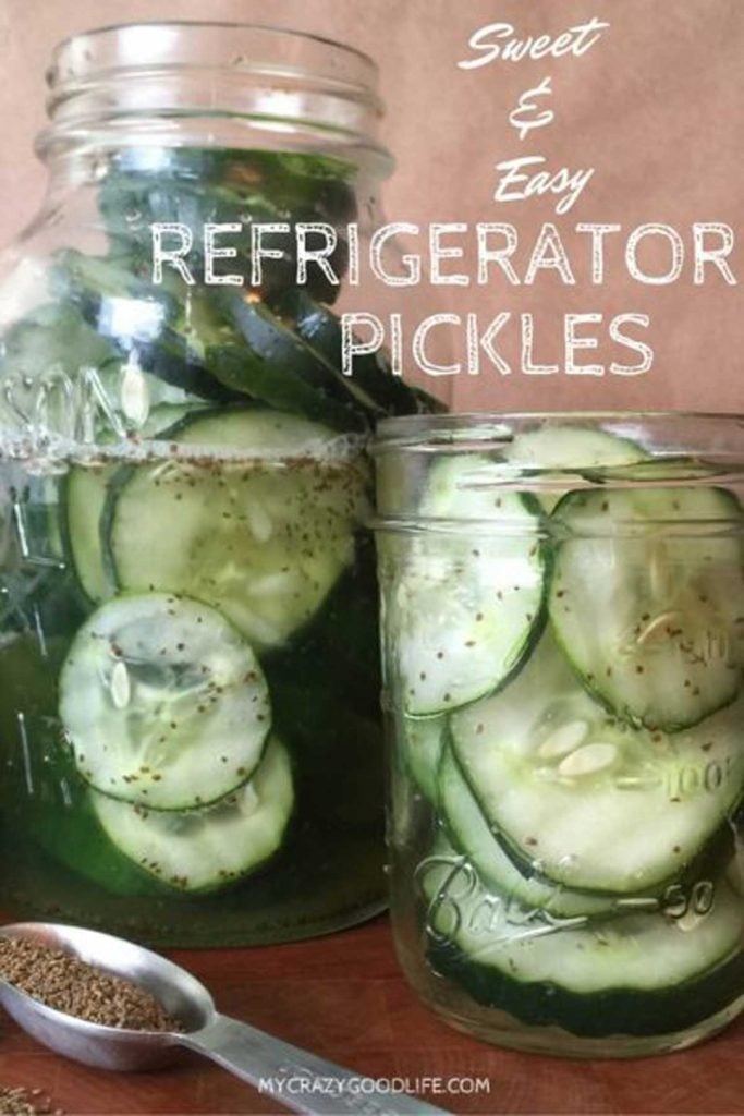 vertical image of two jars of fresh made cucumber pickles, side by side