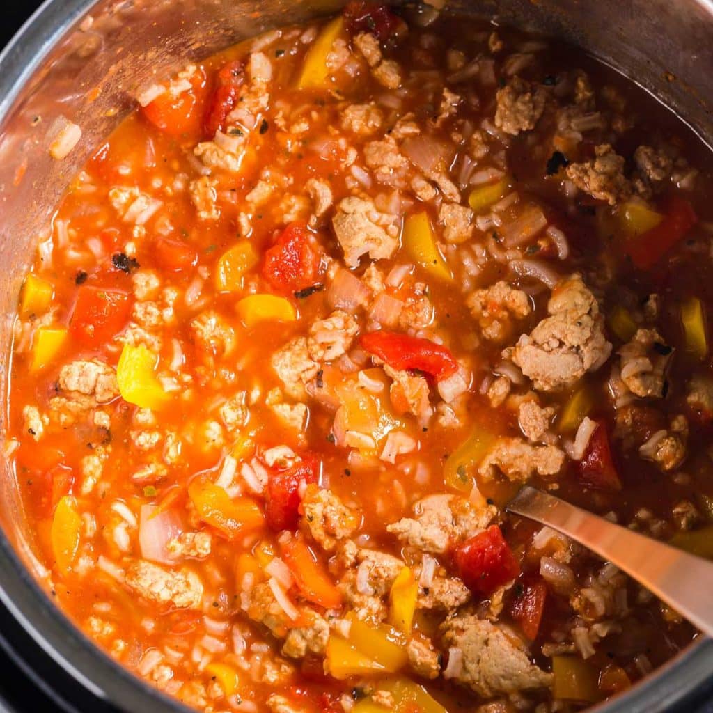 stuffed pepper soup being stirred in an instant pot