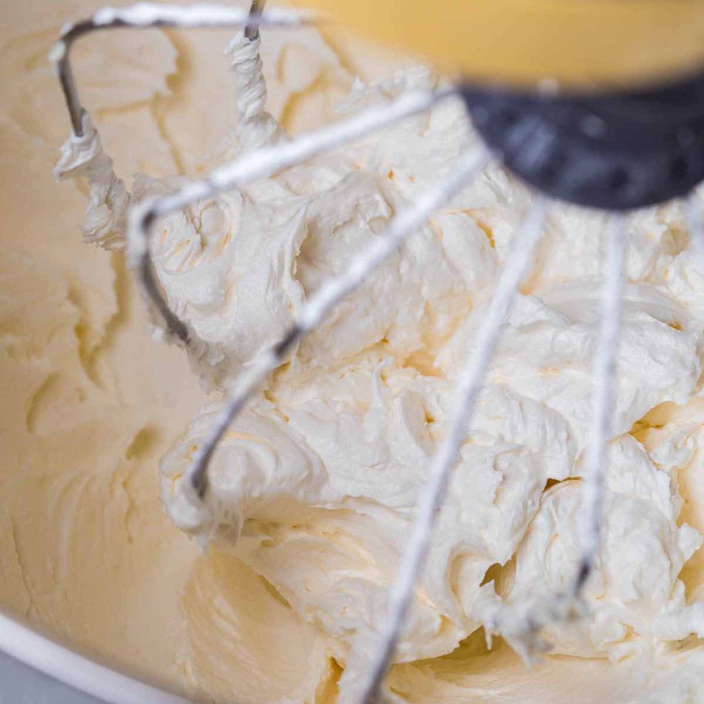 tequila lime frosting being mixed in a silver bowl