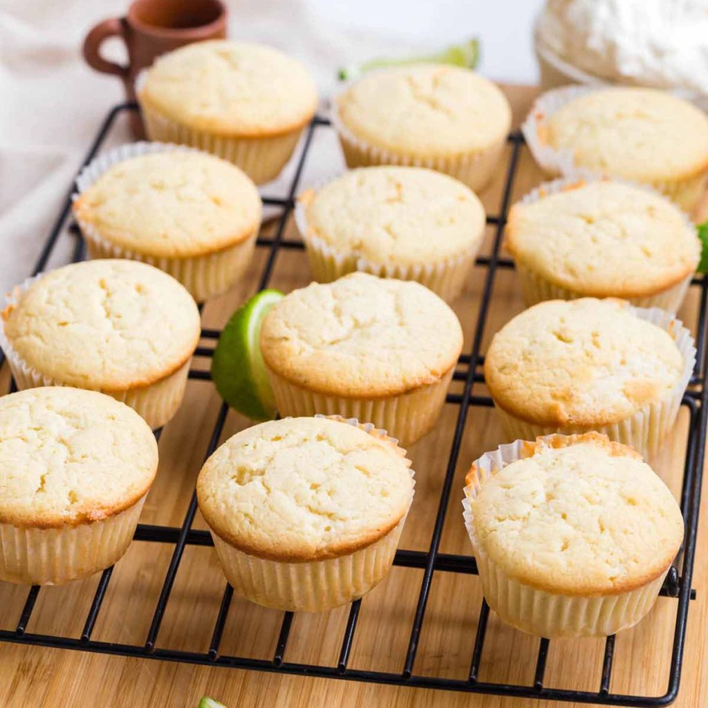 margarita cupcakes on a cooling rack with tequila brushed on top