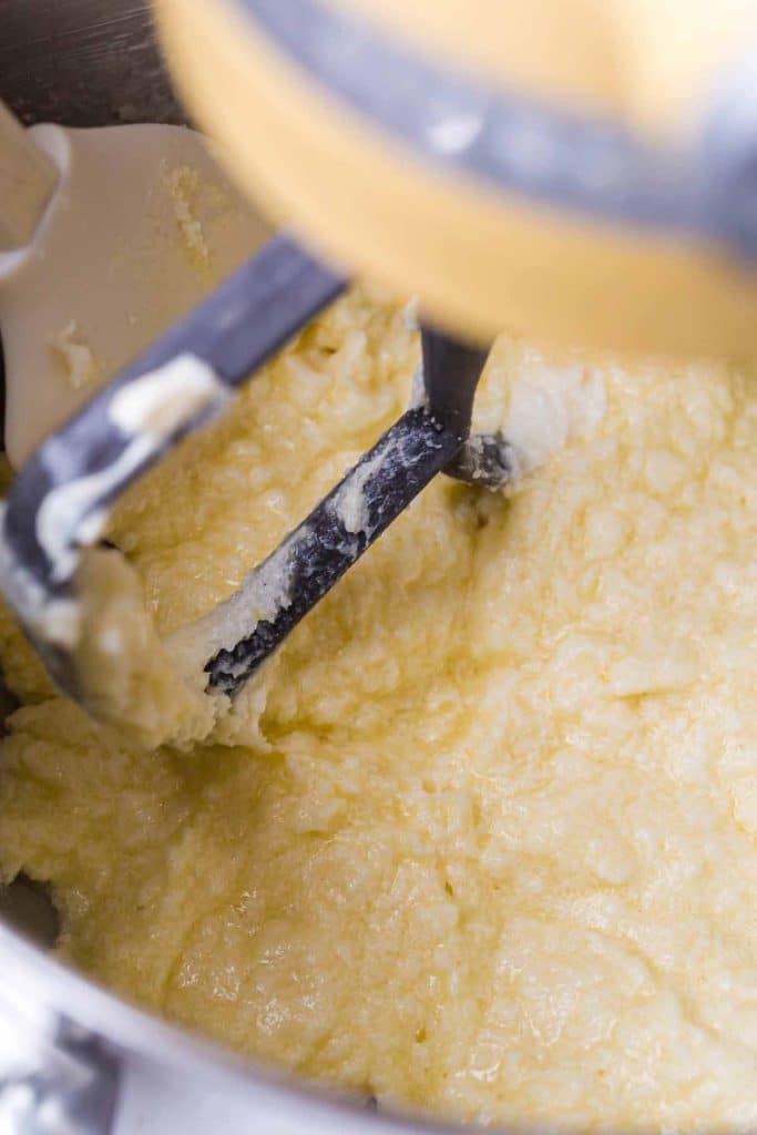 close up view of stand mixer attachment mixing sugar and butter