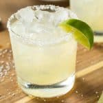 classic margarita recipe in a glass with a lime wedge garnish