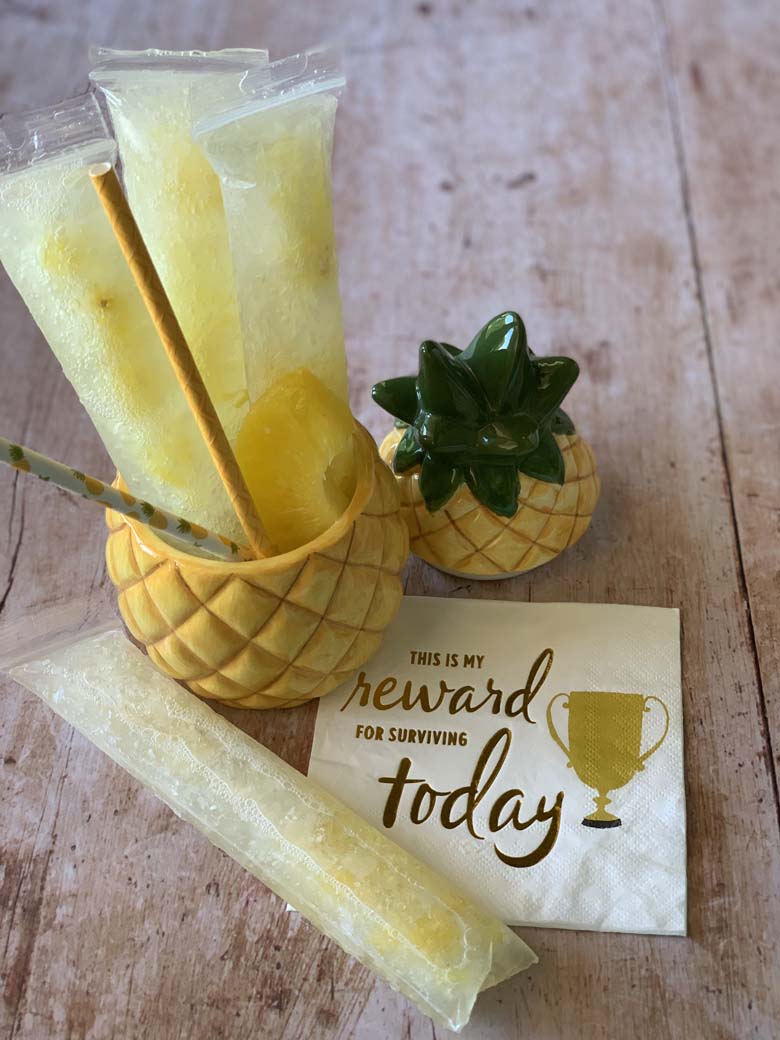 pineapple vodka pops in a pineapple cup with a napkin