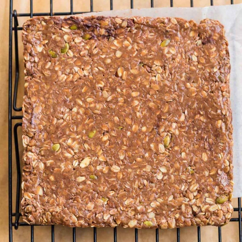 8 by 8 form of granola bar mixture on top of a cooling rack before being cut