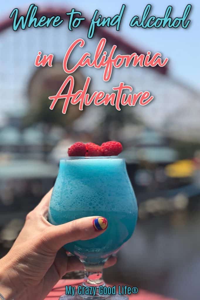 frozen blue cocktail with raspberries on top with Paradise Pier in the background and text with article name