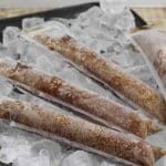 A tray of ice that is topped with dirty pirate popsicles.