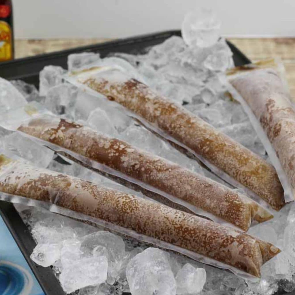 A tray of ice that is topped with dirty pirate popsicles.