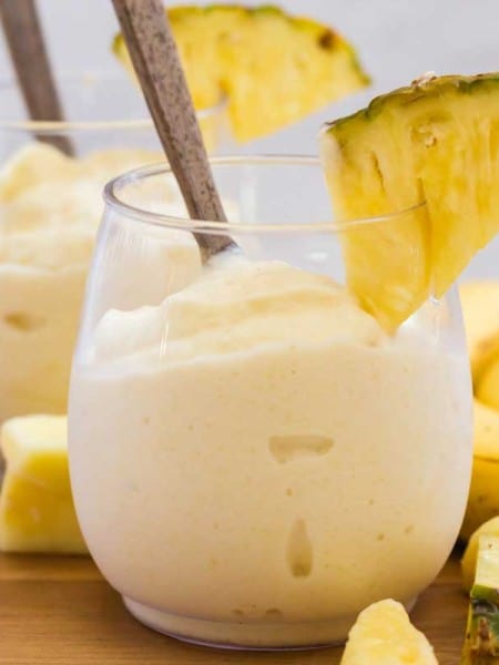 glass full of healthy dole whip and pineapple wedge for garnish