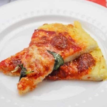 two slices of cooked low carb pizza crust recipe on a white plate.