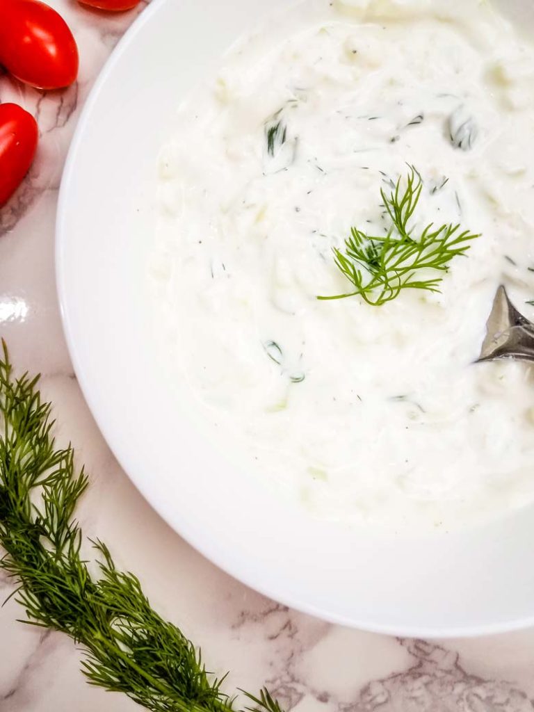 close up of homemade tzatziki sauce in a white bowl 
