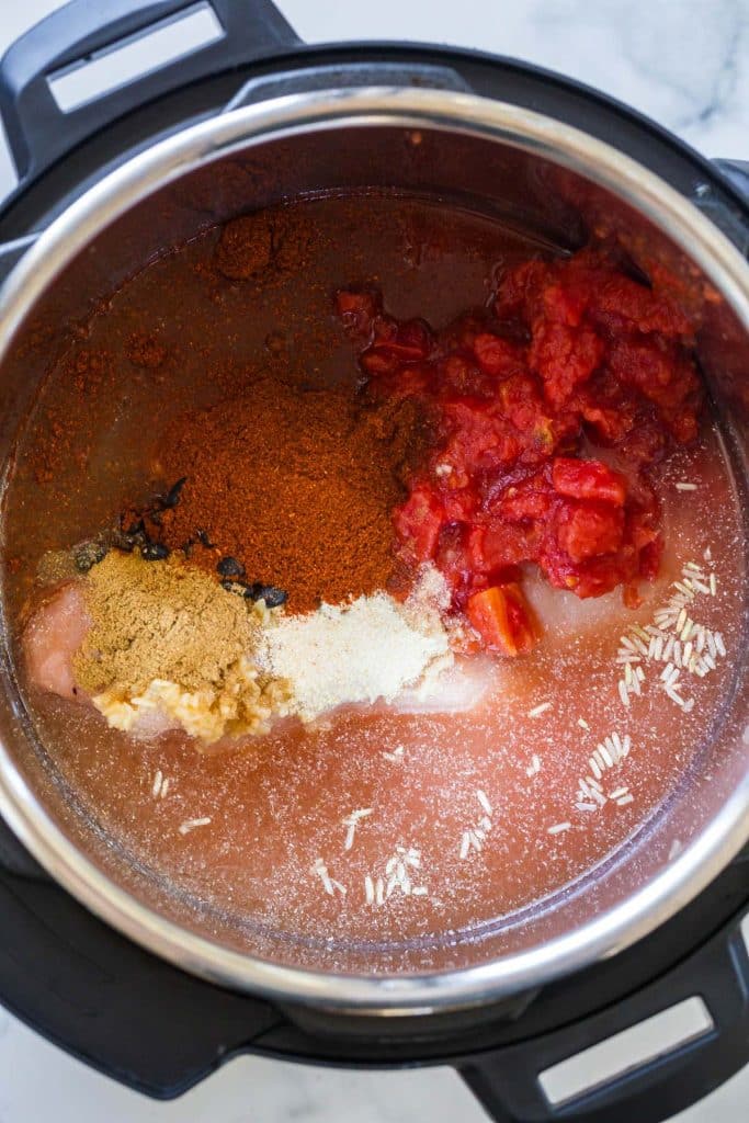 ingredients inside an instant pot to make Chicken Burrito Bowls