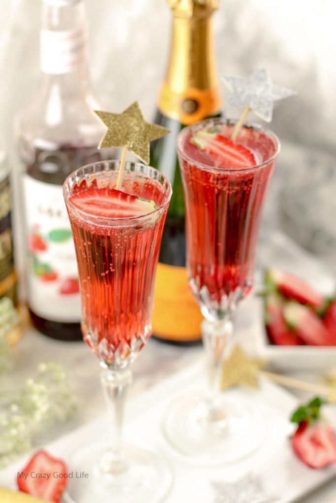 This Strawberry Whiskey Champagne Cocktail will impress your friends! Champagne cocktails are perfect happy hour drinks, as well as celebratory drinks! 