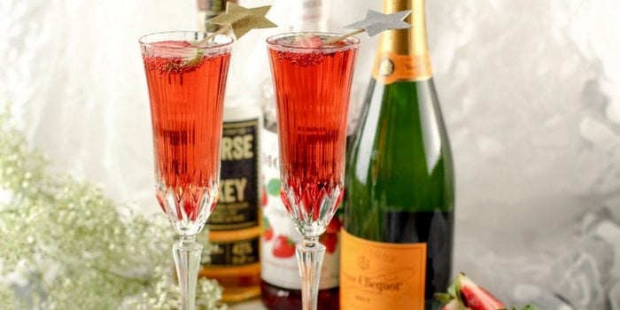 This Strawberry Whiskey Champagne Cocktail will impress your friends! Champagne cocktails are perfect happy hour drinks, as well as celebratory drinks! 