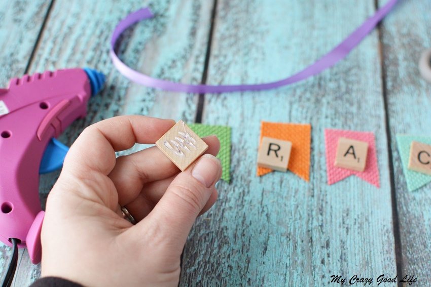 These adorable and customized Easter Baskets are the perfect Scrabble Tile Craft! They're an easy DIY Easter Basket that can be personalized several ways.