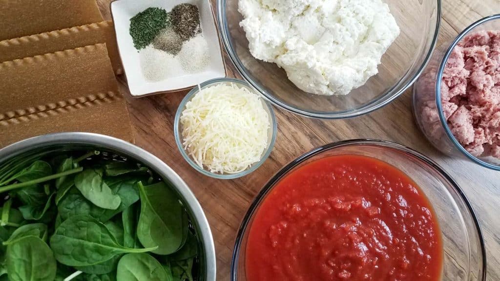 ingredients needed for healthy Instant Pot Lasagna: whole wheat noodles, mozzarella cheese, cottage cheese, tomato sauce, and meat. 