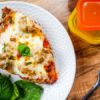 large slice of lasagna on a white plate with 21 day fix containers