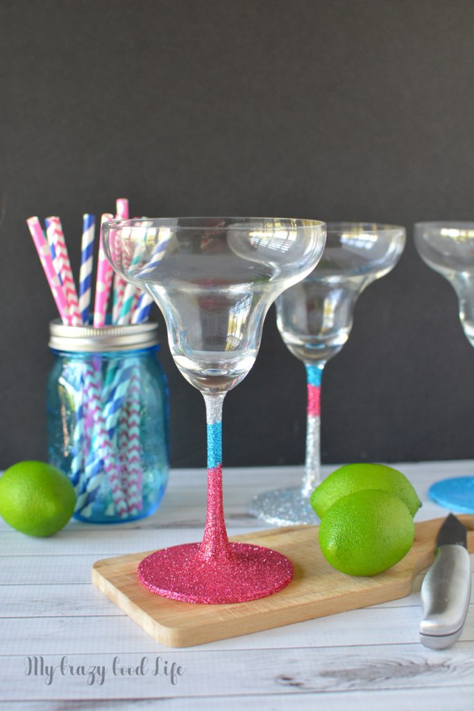 Making DIY glitter margarita glasses is an easy, fun, and useful project. You can keep them for yourself or add them to a gift basket! 