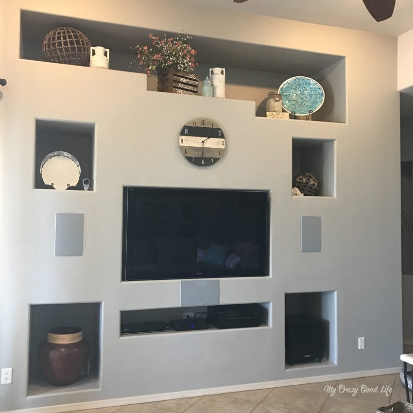 Our Before and After pictures of a home refresh project, which included new decor, a shiplap wall, and a ton of paint! 