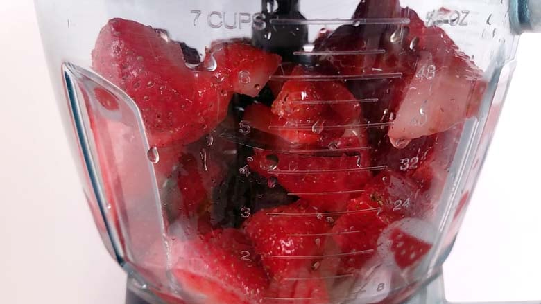 frozen strawberries, honey, and citrus juice in a blender