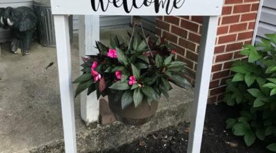 This DIY welcome sign is made with a Cricut and s a great weekend project. It's not too complicated and a DIY plant hanger makes a lovely addition to the front yard, porch, or give it as a gift!