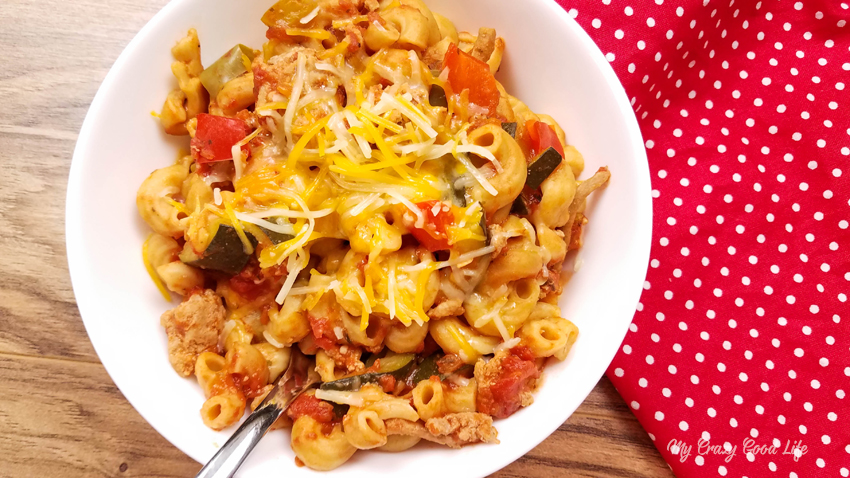 Instant Pot goulash in a white bowl with a spoon. 