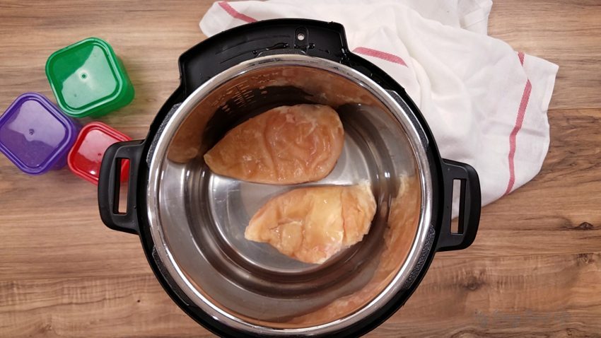Frozen chicken breasts in the Instant Pot ready to be made into Cracked Out Chicken.