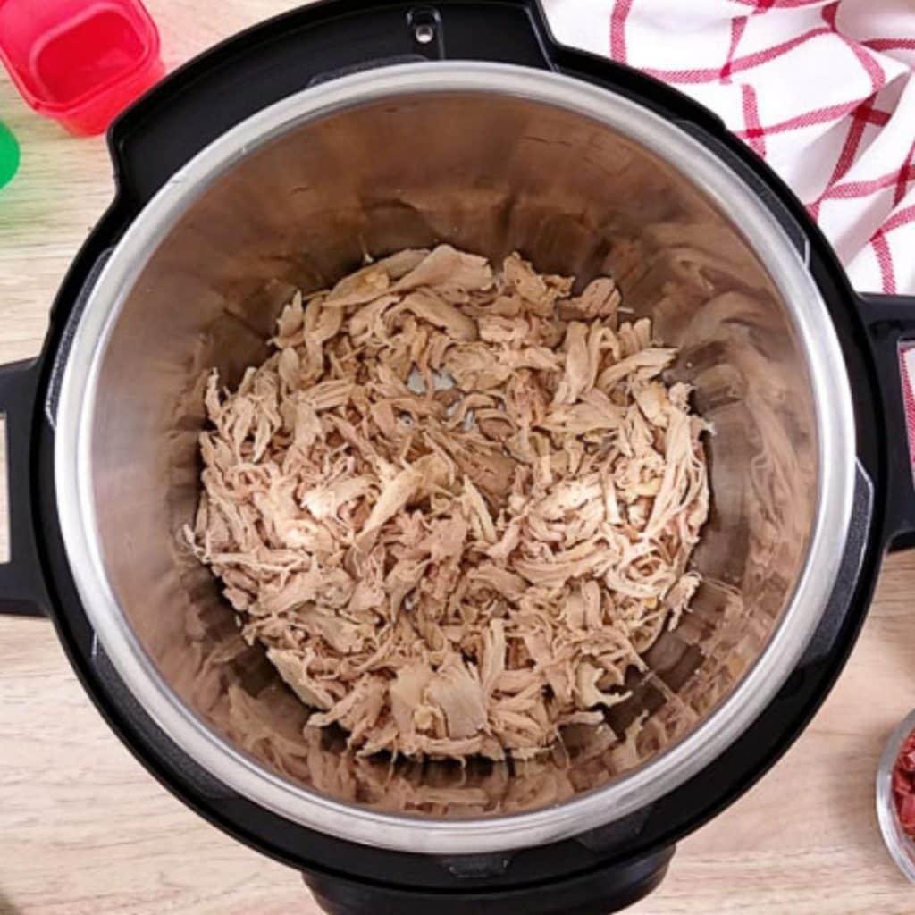 Shredded chicken inside an instant pot.