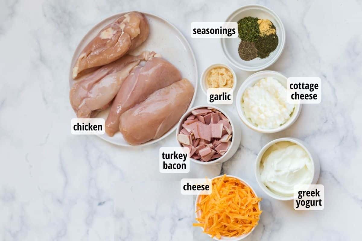 A marble counter top with labeled ingredients that are needed to make Weight Watchers Crack Chicken.