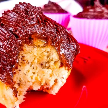 banana cupcakes with chocolate frosting on a red plate