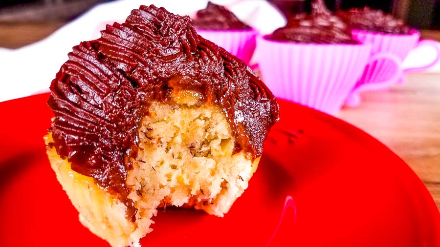 banana cupcakes with chocolate frosting on a red plate