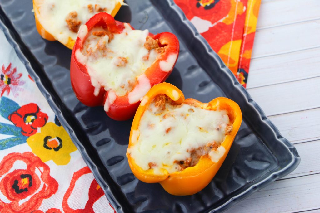 Slow cooker pizza stuffed peppers are a tasty twist on this classic dish. You can make this delicious recipe for lunch, dinner, or as a quick and easy meal prep for the week ahead! #slowcooker #21dayfix #recipes