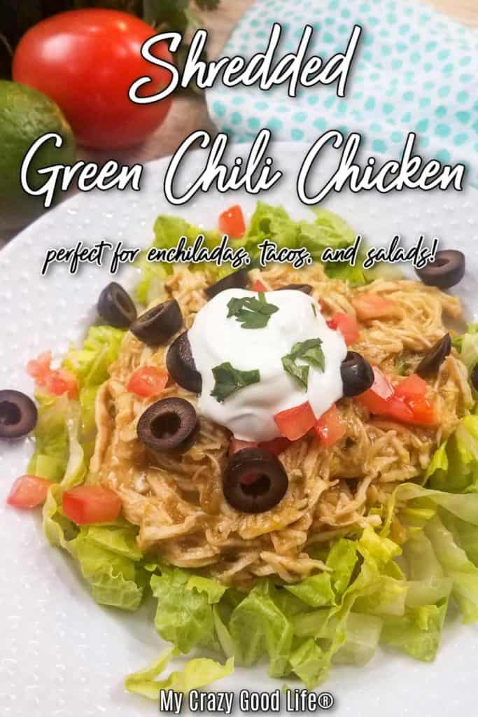 green chili chicken on top of a bed of lettuce on a white plate with text for pinterest