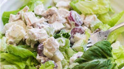 close up of chicken salad on a bed of lettuce