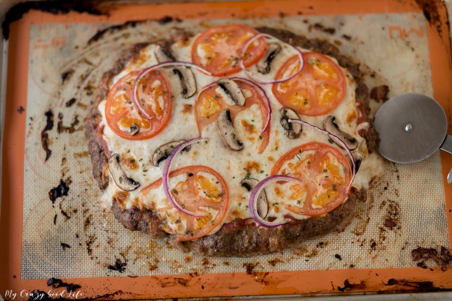 cooked meatza on baking sheet