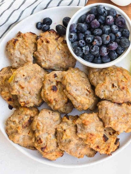 plate with Easy Chicken Apple Sausage Patties and fruit in background