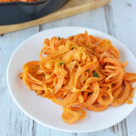 cooked sweet potato pasta on a while plate