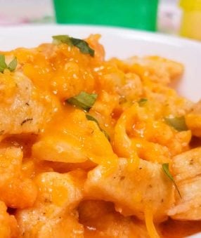 close up of buffalo cauliflower mac and cheese in white bowl
