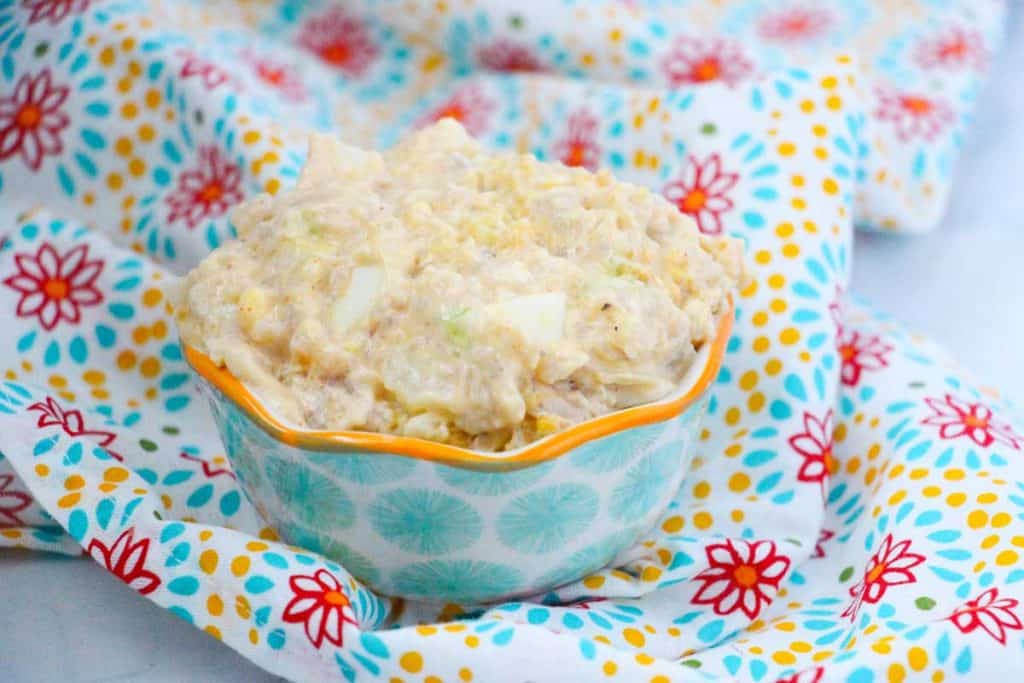 bowl of instant pot cauliflower potato salad on a blue flowered napkin