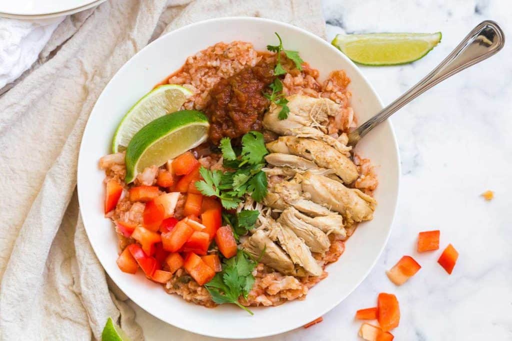 cauliflower rice bowl with chicken in white bowl