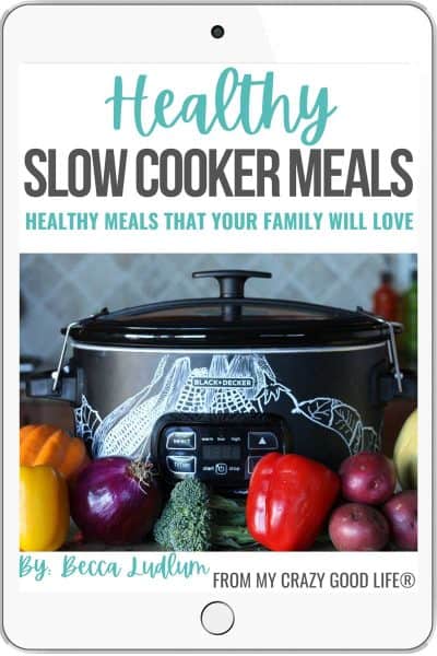 eBook cover of Healthy Slow Coker Meals. Black crockpot sits on counter with fresh vegetables in front of the slow cooker.