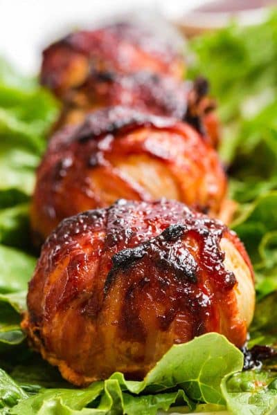 three bbq meatloaf bombs on a bed of lettuce.