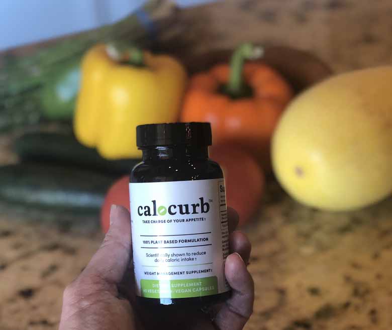 bottle of calocurb in front of healthy food