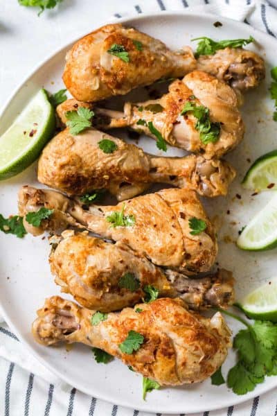 cooked cilantro lime drumsticks on white circular plate