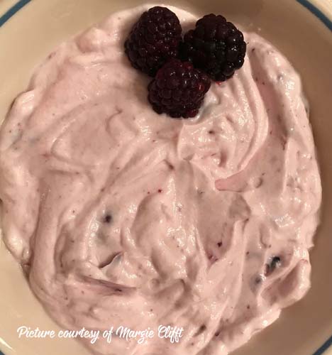 Greek yogurt with raspberries on top and mixed in