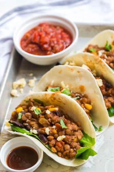 lentil tacos and garnish on a white plate