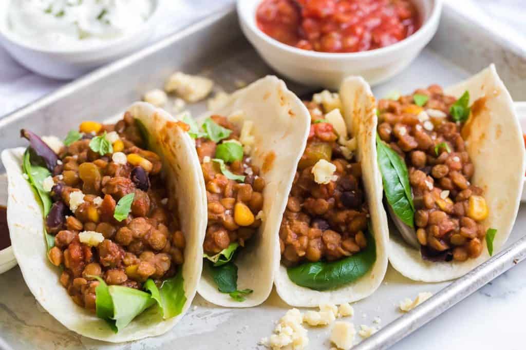prepared lentil tacos on a white plate